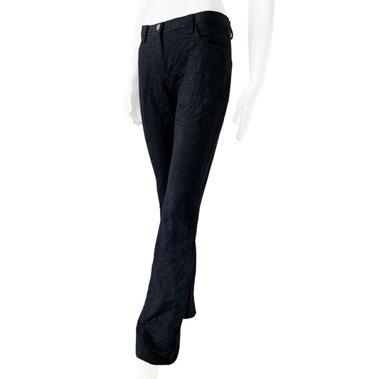 Versace raised all over Greek Key motif black trousers circa 1990’s. High waisted, flared leg with front zipper with silver-tone signature medusa head snap button closure. Front and rear pockets. Tag Size: IT 42 Made in Italy 
