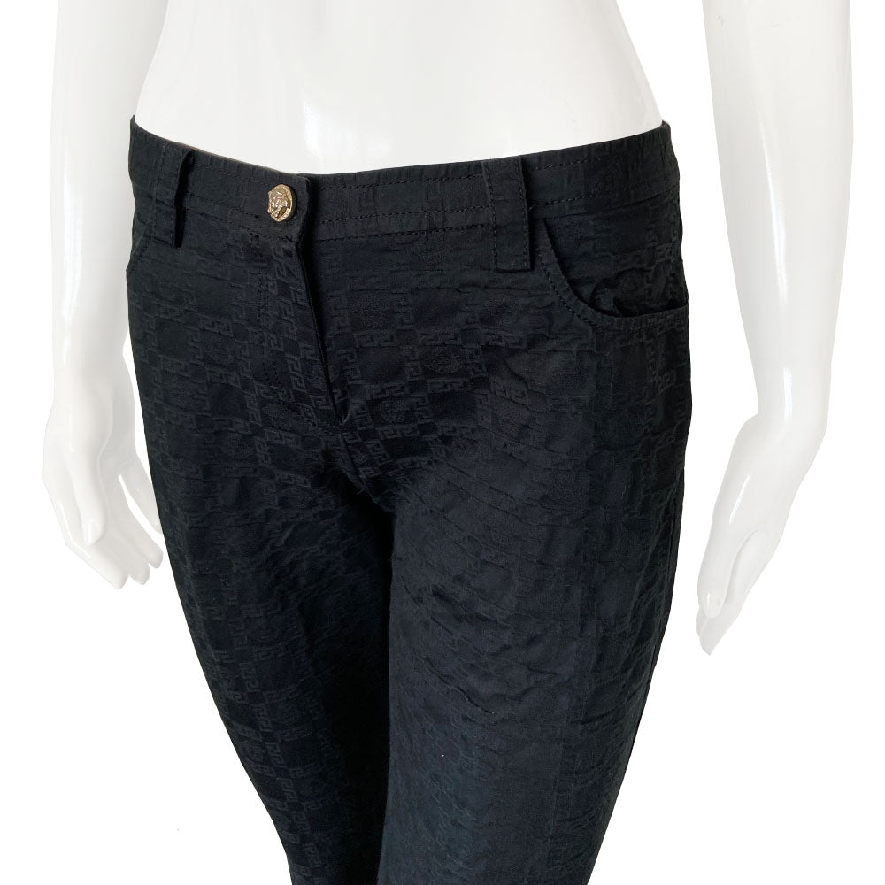 Versace raised all over Greek Key motif black trousers circa 1990’s. High waisted, flared leg with front zipper with silver-tone signature medusa head snap button closure. Front and rear pockets. Tag Size: IT 42 Made in Italy 