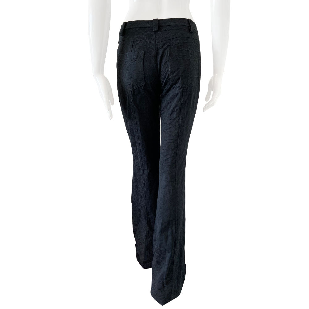 Versace raised all over Greek Key motif black trousers circa 1990’s. High waisted, flared leg with front zipper with silver-tone signature medusa head snap button closure. Front and rear pockets. Tag Size: IT 42 Made in Italy 