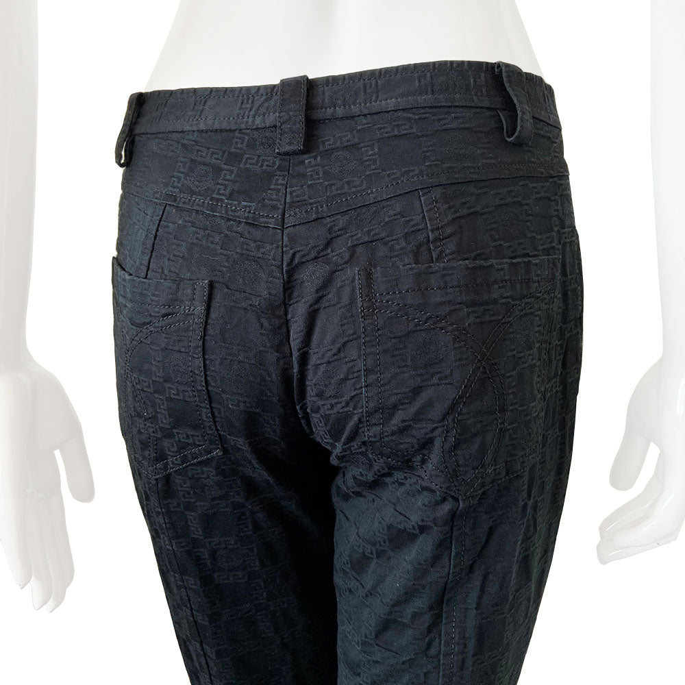 Versace raised all over Greek Key motif black trousers circa 1990’s. High waisted, flared leg with front zipper with silver-tone signature medusa head snap button closure. Front and rear pockets. Tag Size: IT 42 Made in Italy 