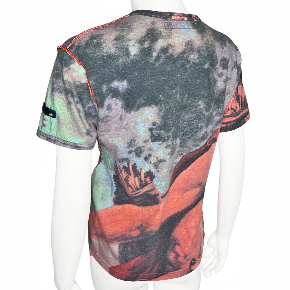 Short sleeve all-over printed tee featuring a man and woman in loving embrace Open neck tied with faux suede ties through silver-tone grommets, exposed seams at shoulders and side seams. Studded VP Logo on front lower left and crystal embellished velvet patch at shoulder. 