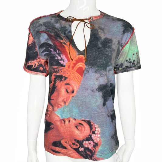 Short sleeve all-over printed tee featuring a man and woman in loving embrace Open neck tied with faux suede ties through silver-tone grommets, exposed seams at shoulders and side seams. Studded VP Logo on front lower left and crystal embellished velvet patch at shoulder. 
